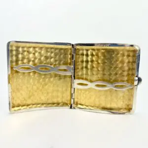 Open gold and silver cigarette case.