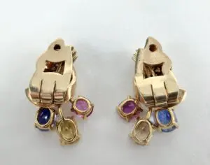 Gold earrings with colorful gemstone accents.