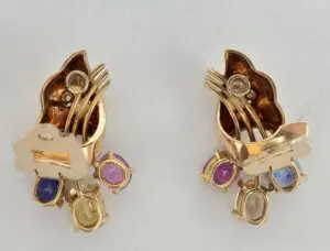 Gold earrings with colorful gemstones.