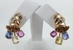 Gold earrings with colorful gemstone dangles.