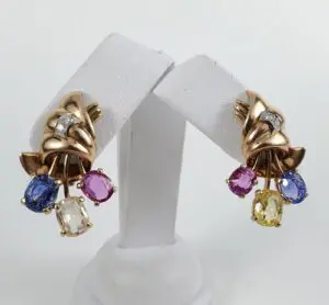 Gold earrings with colorful gemstone dangles.