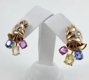 Gold earrings with colorful gemstone accents.
