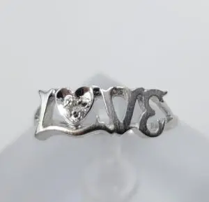 Silver ring with "LOVE" design.