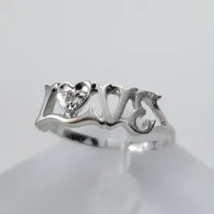 Silver ring with "love" and heart design.