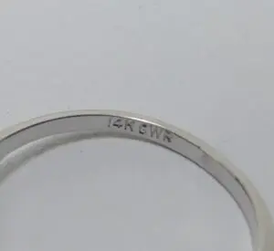 14K white gold ring engraving close-up.