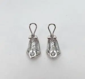 Silver zipper pulls on white background.