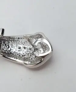 Silver metallic clasp on a white background.