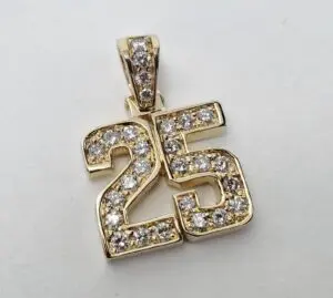 Gold pendant with diamond-studded number 25.