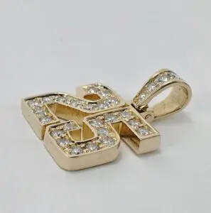 Gold swastika pendant with embedded diamonds.