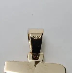 Gold pendant with rectangular shape and bail.