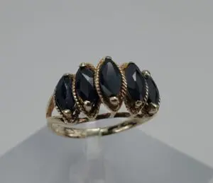 Gold ring with black marquise gemstones.