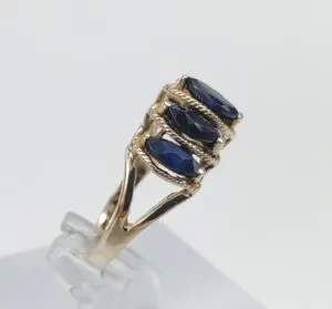 Gold ring with three blue gemstones.