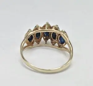 Gold ring with blue gemstone accents.