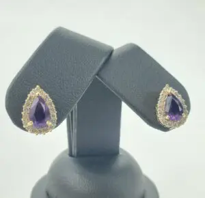 Purple teardrop earrings with diamond accents.