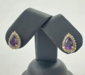 Purple teardrop earrings with diamond accents.