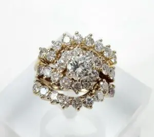 Gold ring with multiple diamond clusters.