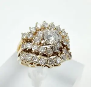 Gold ring with multiple diamond clusters.