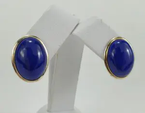 Blue oval earrings with gold trim.