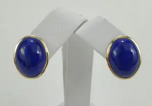Gold-framed blue stone earrings on display.