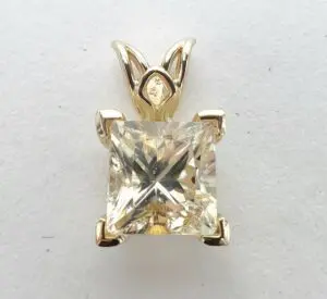 Square-cut diamond pendant with gold setting.