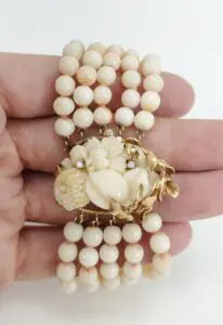 Pearl bracelet with floral clasp design.