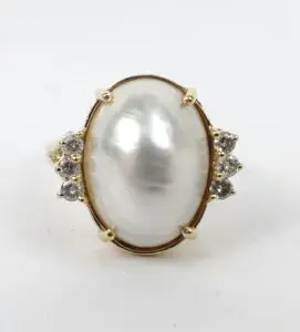 Oval pearl ring with diamond accents.