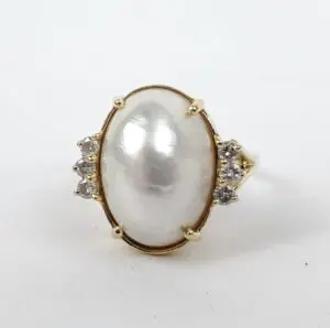 Gold ring with large pearl and diamonds.