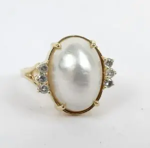 Gold ring with large pearl centerpiece.