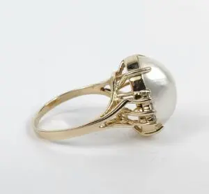 Gold ring with large pearl setting.