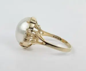 Gold ring with large pearl setting.
