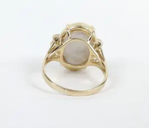 Gold ring with oval stone setting.