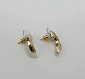 Gold crescent moon earrings on white background.