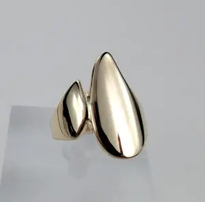 Gold abstract modern design ring on display.