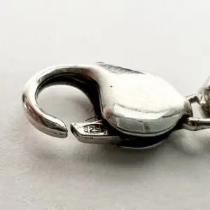 Silver lobster clasp for jewelry, close-up.
