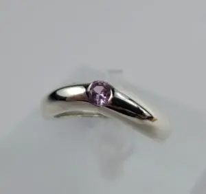 Silver ring with a purple gemstone.