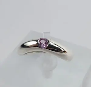 Silver ring with a purple gemstone.