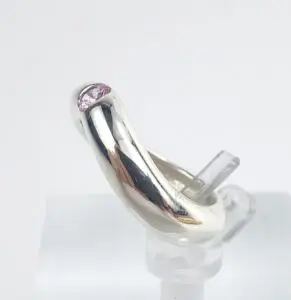 Silver ring with a pink gemstone.