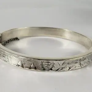 Silver engraved bracelet with geometric patterns.