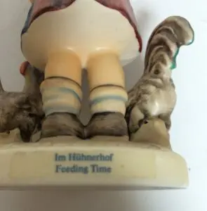 Porcelain figurine of child with chickens.