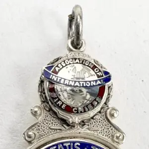 Silver International Fire Chiefs Association pendant.