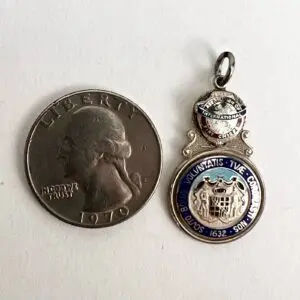 Coin and a blue enamel medallion.