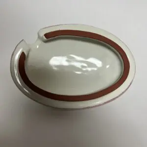Oval ceramic ashtray with brown trim.