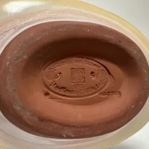 Engraved pottery base with company logo.