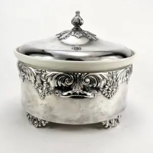 Ornate silver dish with decorative lid.
