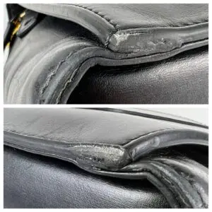 Worn edges of black leather bag.