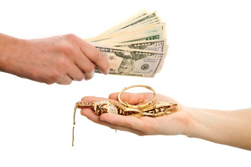 One Hand Handing Cash And One Hand Handing Gold Jewelry