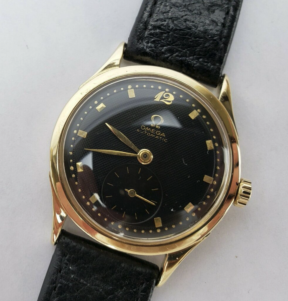 Omega Watch with black leather band on white background