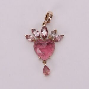 Pink heart gemstone pendant with teardrop accents.
