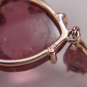 Close-up of a pink gemstone pendant.