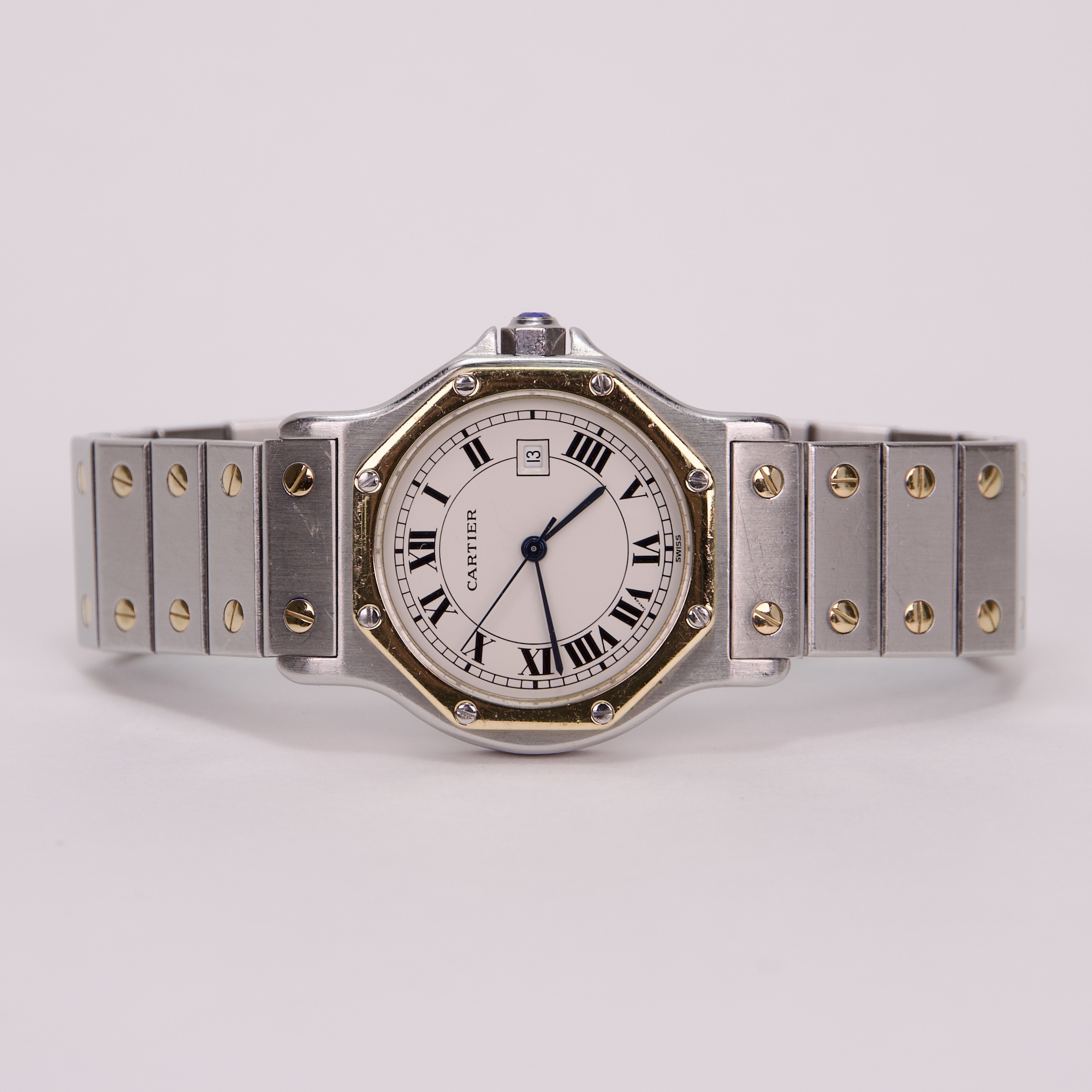 Silver and gold wristwatch with Roman numerals.